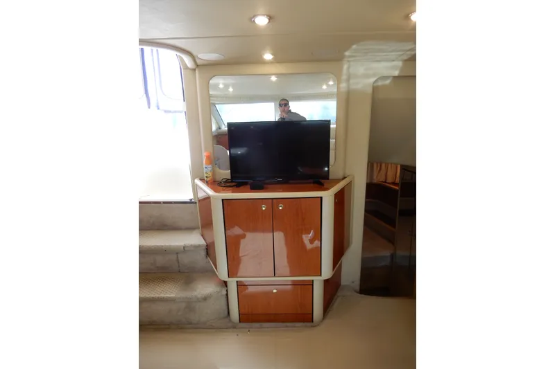 Slide: The Image of Interior of 2000 Sea Ray 380 Aft Cabin with TV and wooden cabinetry. - 45