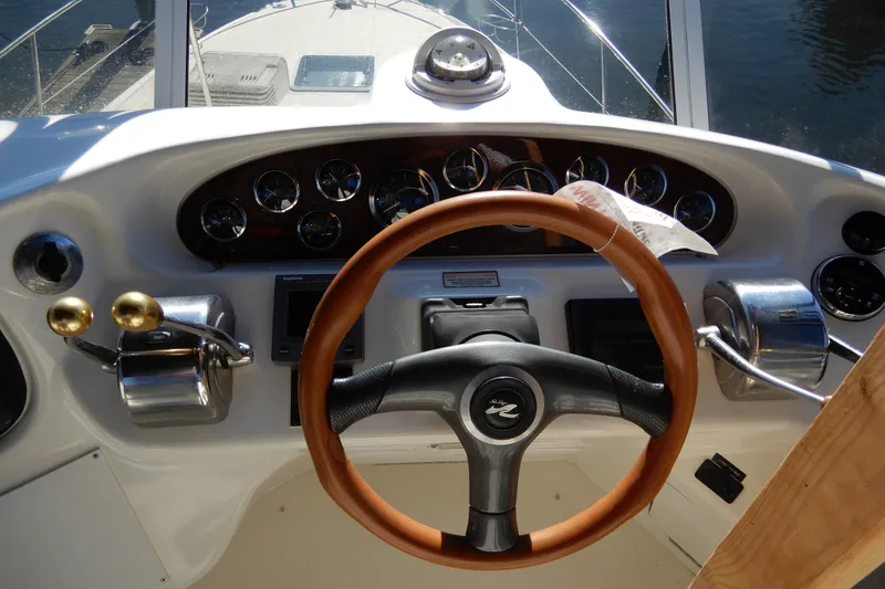 Slide: The Image of Helm of 2000 Sea Ray 380 Aft Cabin yacht with wooden steering wheel and controls. - 25