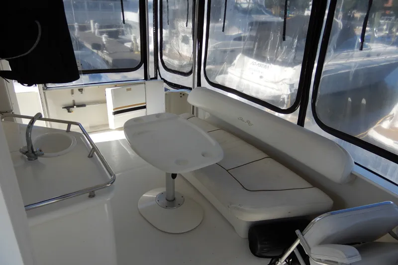 Slide: The Image of 2000 Sea Ray 380 Aft Cabin interior with seating, table, and sink. - 12