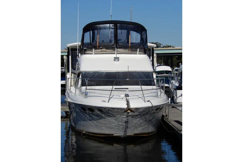 Slide: The Image of 2000 Sea Ray 380 Aft Cabin yacht docked at marina, front view. - 1