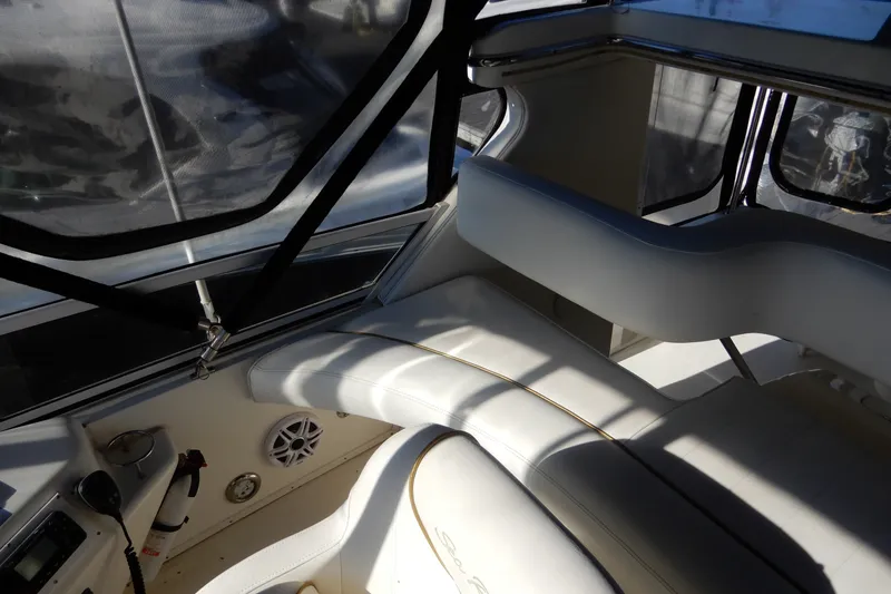 Slide: The Image of Interior of 2000 Sea Ray 380 Aft Cabin yacht with white seating and controls. - 21