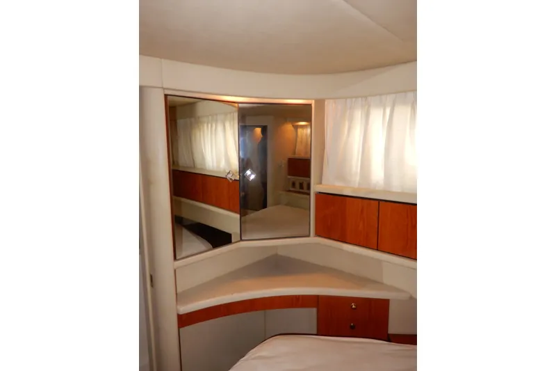 Slide: The Image of Interior of 2000 Sea Ray 380 Aft Cabin with mirrored wall and wooden cabinetry. - 69