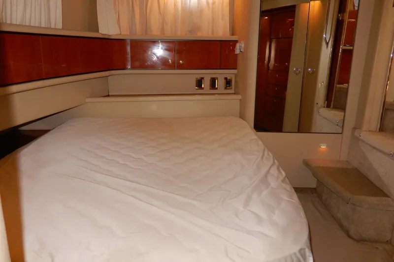 Slide: The Image of Cozy bedroom interior of 2000 Sea Ray 380 Aft Cabin yacht with elegant wood accents. - 66