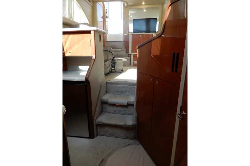Slide: The Image of Interior of 2000 Sea Ray 380 Aft Cabin yacht with stairs and wooden cabinetry. - 53