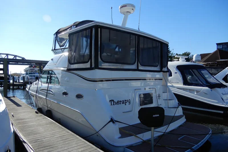 Slide: The Image of 2000 Sea Ray 380 Aft Cabin yacht docked at marina under clear blue sky. - 5