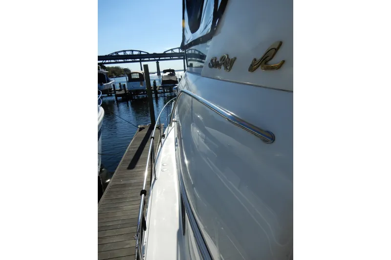 Slide: The Image of 2000 Sea Ray 380 Aft Cabin yacht docked at marina, side view with logo. - 37