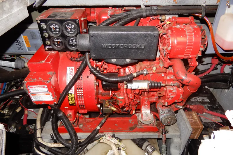 Slide: The Image of Engine compartment of a 2000 Sea Ray 380 Aft Cabin with a red Westerbeke generator. - 83