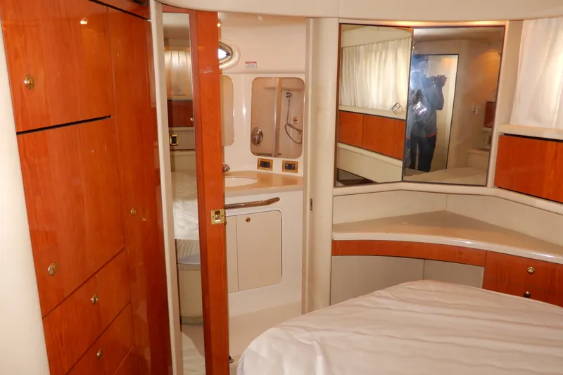 Slide: The Image of Interior of 2000 Sea Ray 380 Aft Cabin with wood cabinetry and mirrored accents. - 71