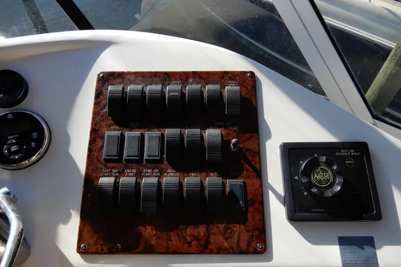 Slide: The Image of Control panel of a 2000 Sea Ray 380 Aft Cabin boat with switches and navigation pad. - 27