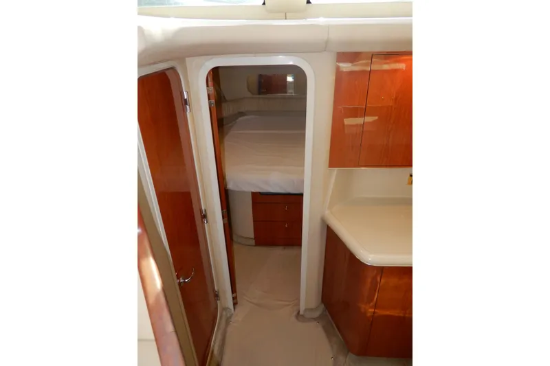 Slide: The Image of Interior of 2000 Sea Ray 380 Aft Cabin with wood cabinetry and cozy bedroom. - 58