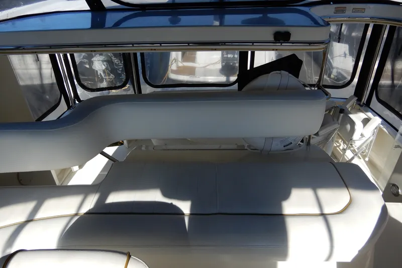 Slide: The Image of Interior view of 2000 Sea Ray 380 Aft Cabin with white seating and windows. - 22