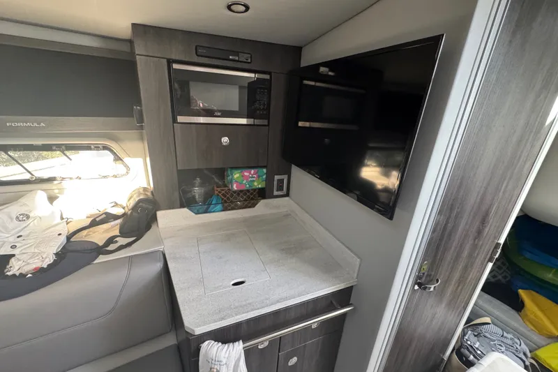 Slide: The Image of Interior of 2022 Formula 400 Super Sport Crossover with modern kitchenette and TV. - 35