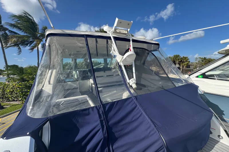 Slide: The Image of 2022 Formula 400 Super Sport Crossover boat with blue cover and clear canopy. - 18