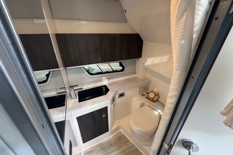 Slide: The Image of Luxurious bathroom in 2022 Formula 400 Super Sport Crossover boat, featuring modern fixtures and cabinetry. - 32