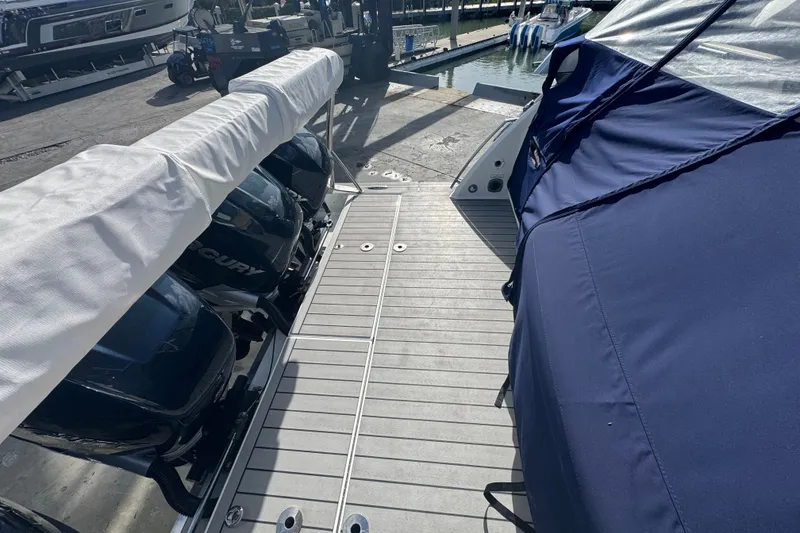 Slide: The Image of 2022 Formula 400 Super Sport Crossover boat docked with covered engines. - 16