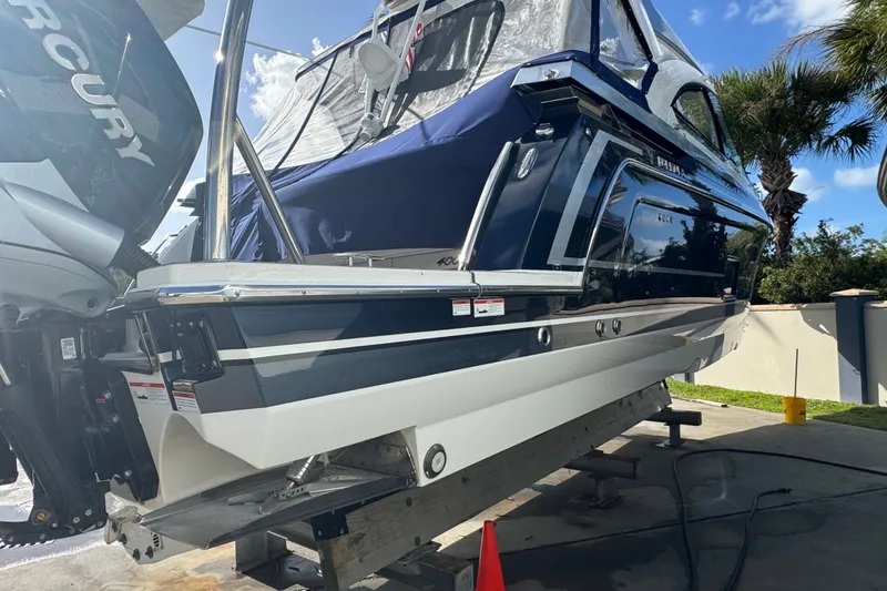 The Image of 2022 Formula 400 Super Sport Crossover boat on a lift, featuring Mercury engines. - 0