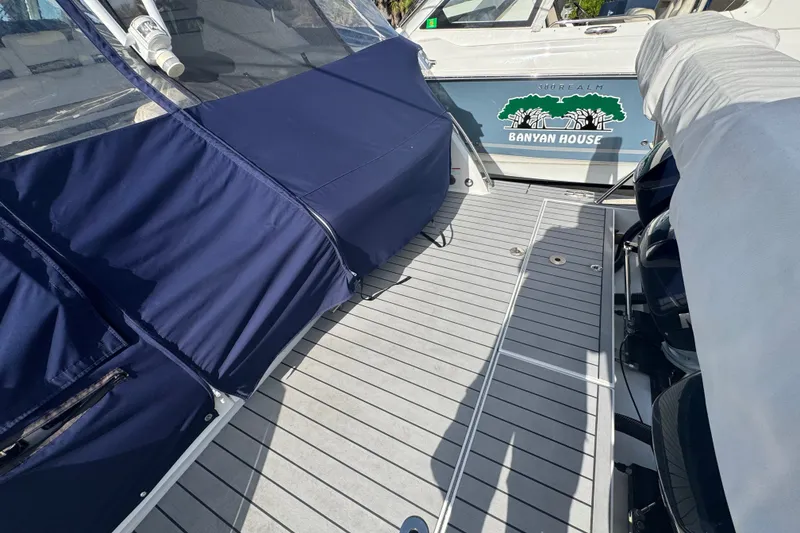 Slide: The Image of 2022 Formula 400 Super Sport Crossover boat deck with blue and gray covers. - 17