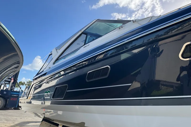 Slide: The Image of 2022 Formula 400 Super Sport Crossover boat under clear blue sky. - 13