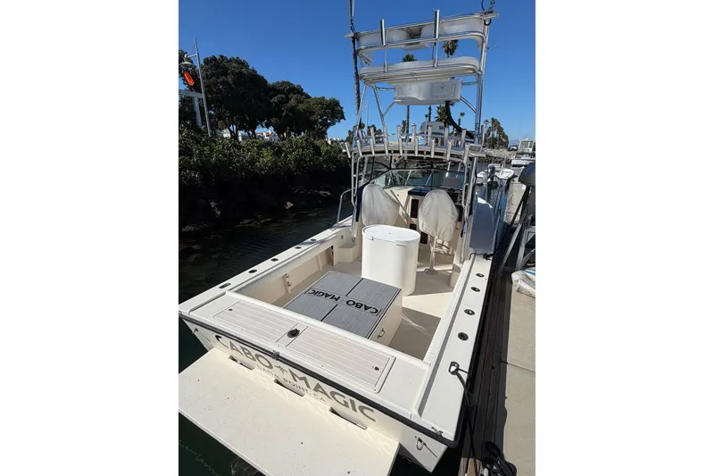 Slide: The Image of 2001 Austin Parker 2510DV boat docked, featuring a spacious deck and fishing equipment. - 4
