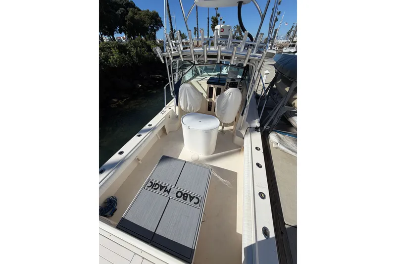 Slide: The Image of 2001 Austin Parker 2510DV boat interior with fishing rod holders and seating. - 28