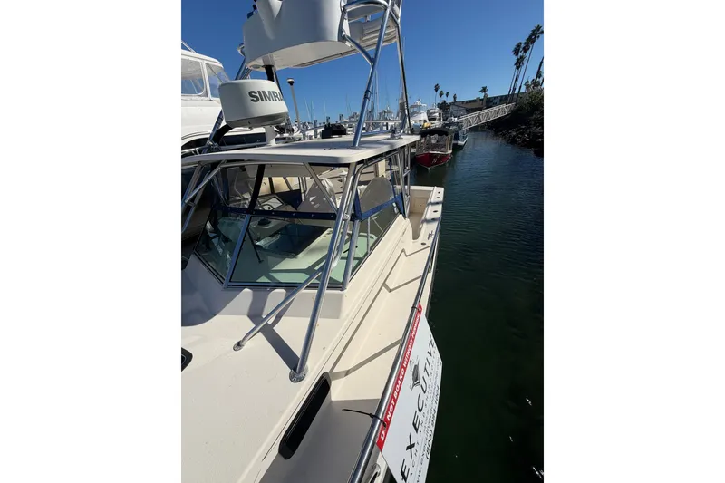 Slide: The Image of 2001 Austin Parker 2510DV boat docked in a marina under clear blue skies. - 22