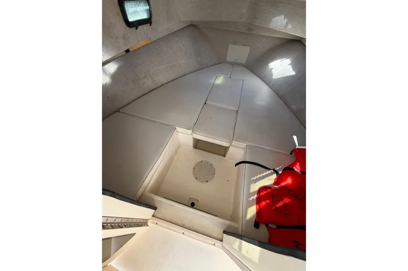 Slide: The Image of Interior cabin of 2001 Austin Parker 2510DV boat with seating and life jackets. - 11