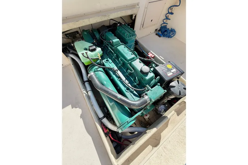 Slide: The Image of Engine compartment of a 2001 Austin Parker 2510DV boat, showcasing a green marine engine. - 6