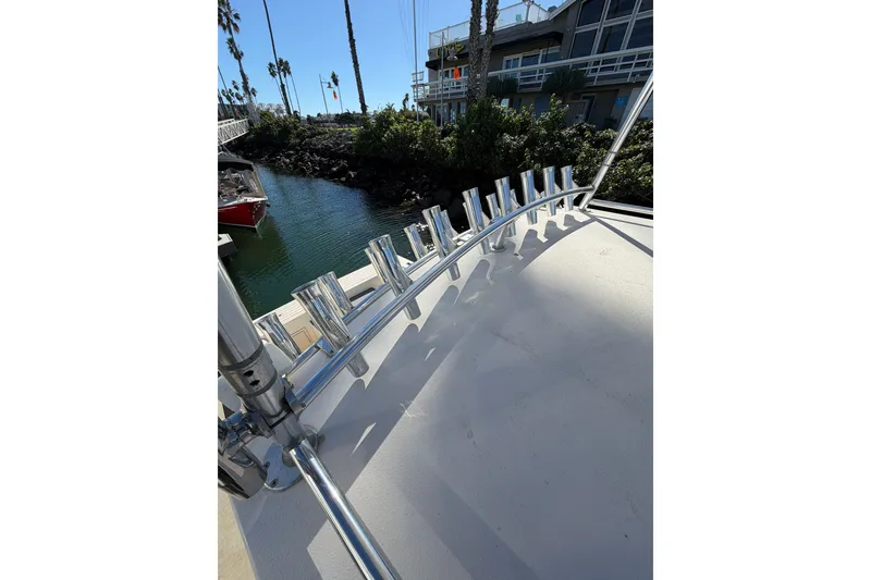 Slide: The Image of Rooftop view of 2001 Austin Parker 2510DV boat with chrome rod holders, dockside. - 26