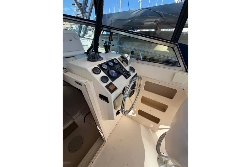 Slide: The Image of 2001 Austin Parker 2510DV boat cockpit with steering wheel and control panel. - 12