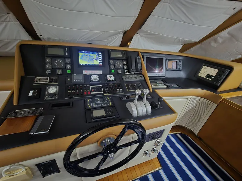 Slide: The Image of Cockpit of 1994 Hatteras 82 Convertible yacht with navigation instruments and steering wheel. - 15