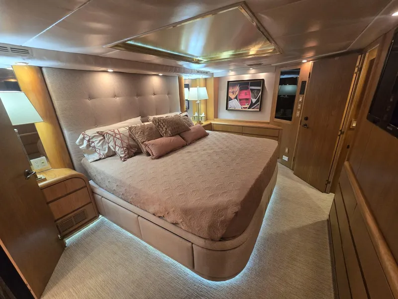 Slide: The Image of Luxurious bedroom interior of 1994 Hatteras 82 Convertible yacht with elegant lighting and decor. - 21