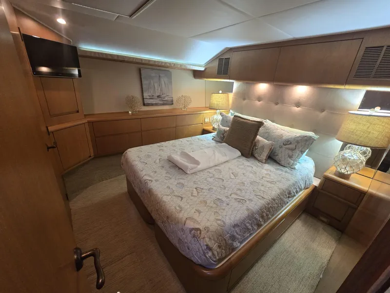 Slide: The Image of Luxurious bedroom interior of 1994 Hatteras 82 Convertible yacht with elegant bedding and ambient lighting. - 29
