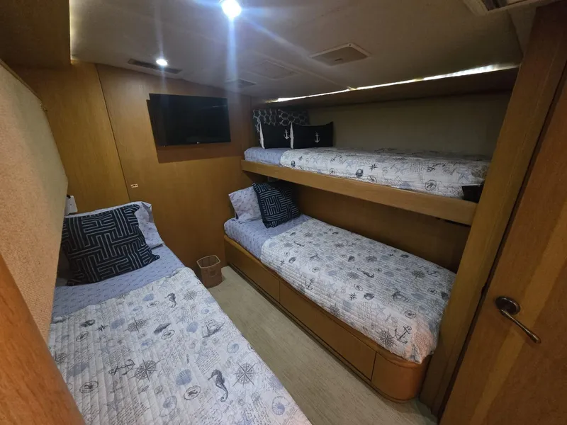 Slide: The Image of Interior of 1994 Hatteras 82 Convertible yacht with three cozy bunk beds. - 31