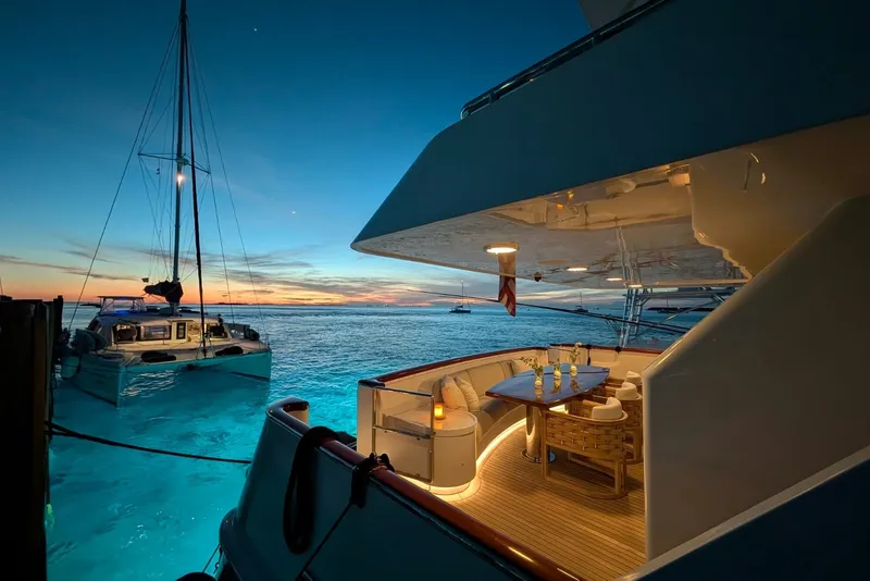 Slide: The Image of Luxurious Delta Marine 110 yacht at sunset, featuring elegant outdoor dining area. - 12