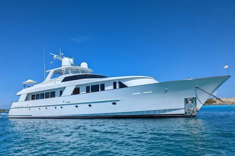 Slide: The Image of Delta Marine 110 Raised Pilothouse yacht, 1994, anchored in clear blue waters. - 5