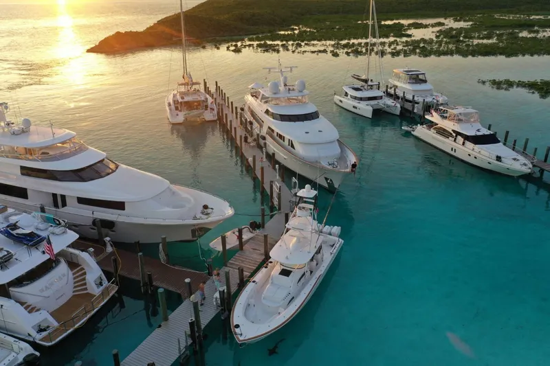 Slide: The Image of Docked yachts at sunset, featuring a 1994 Delta Marine 110 Raised Pilothouse. - 17