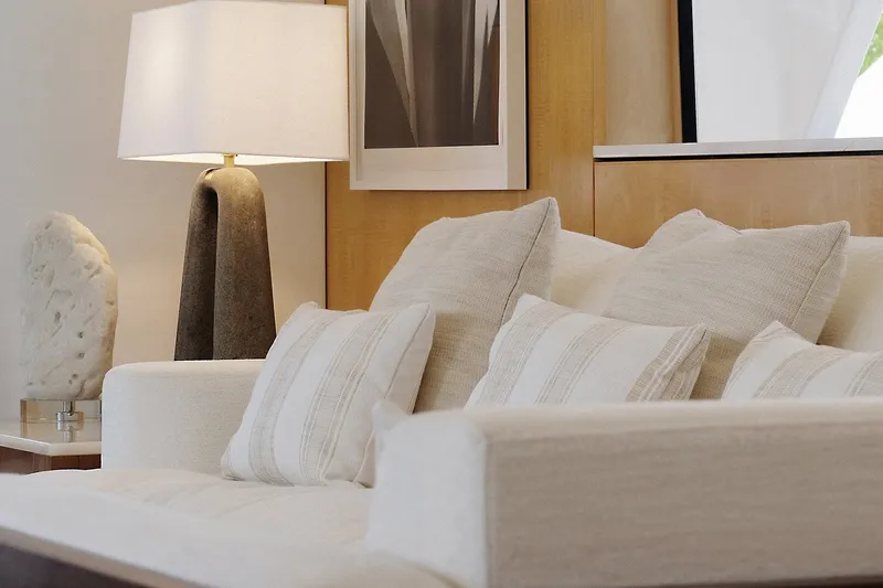 Slide: The Image of Luxurious yacht interior with plush white sofa, decorative pillows, and elegant lamp. Delta Marine 110 Raised Pilothouse. - 30