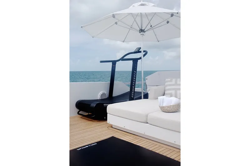 Slide: The Image of Luxury yacht deck with treadmill, sun umbrella, and seating on Delta Marine 110 Raised Pilothouse, 1994. - 40