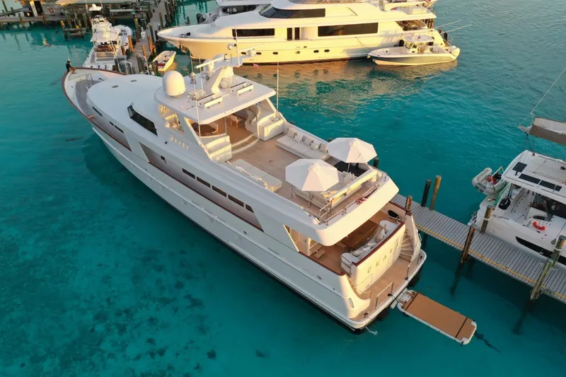 Slide: The Image of Luxurious 1994 Delta Marine 110 Raised Pilothouse yacht docked in clear turquoise waters. - 23
