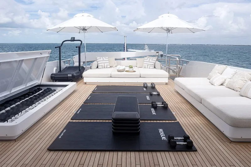 Slide: The Image of Luxury yacht deck with gym equipment, lounge seating, and ocean view; Delta Marine 110 Raised Pilothouse, 1994. - 39