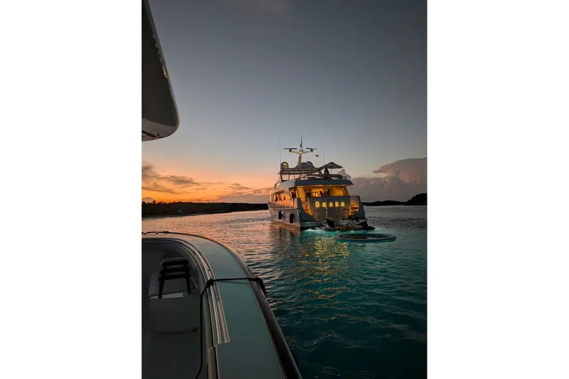 Slide: The Image of Delta Marine 110 Raised Pilothouse yacht at sunset, 1994 model, anchored on calm water. - 14