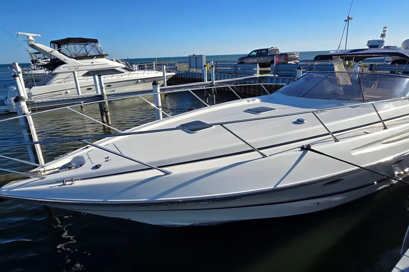 Slide: The Image of 1994 Sunseeker Mustique 42 yacht docked at marina under clear blue sky. - 5