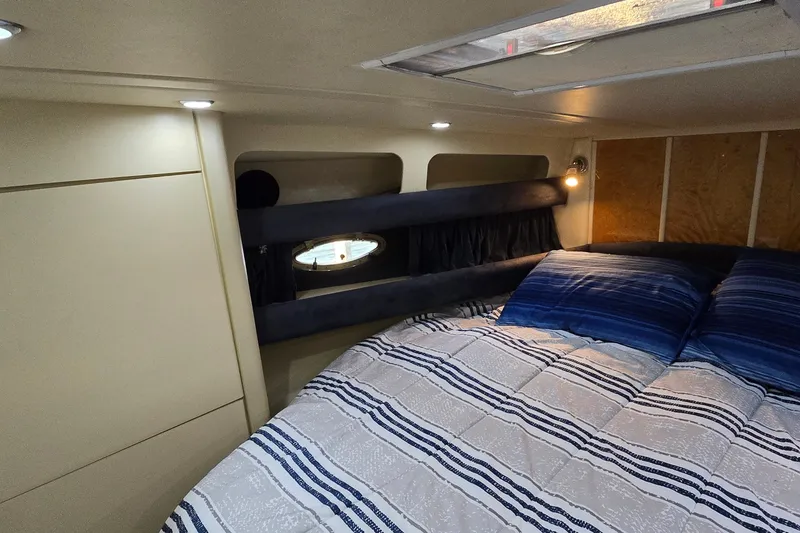 Slide: The Image of Cozy cabin interior of 1994 Sunseeker Mustique 42 with bed and porthole window. - 18