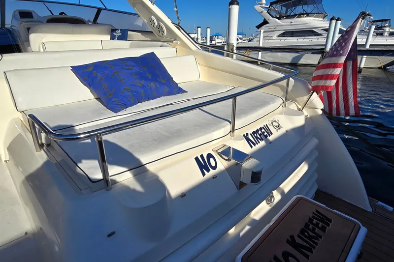 Slide: The Image of Sunseeker Mustique 42 yacht, 1994 model, with American flag and blue anchor-patterned cushion. - 7