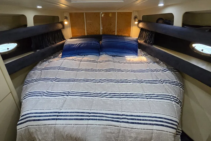 Slide: The Image of Cozy cabin interior of 1994 Sunseeker Mustique 42 yacht with striped bedding. - 17