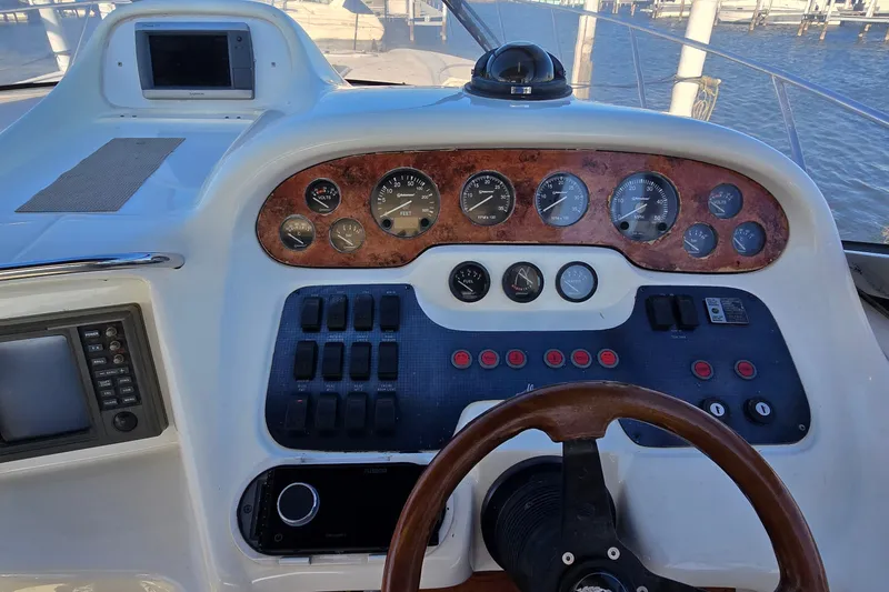 Slide: The Image of 1994 Sunseeker Mustique 42 yacht dashboard with gauges and controls. - 12