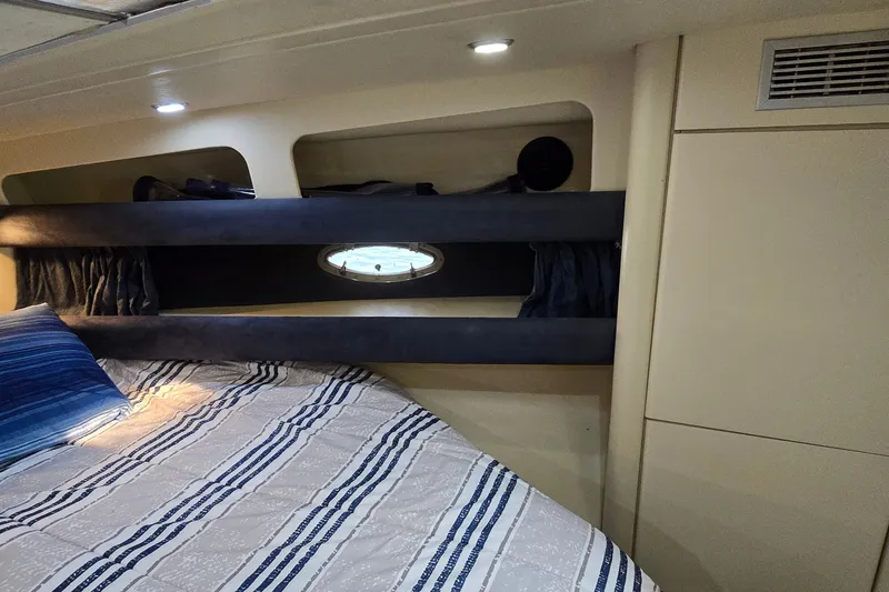 Slide: The Image of Interior cabin of 1994 Sunseeker Mustique 42 yacht with bed and porthole window. - 19