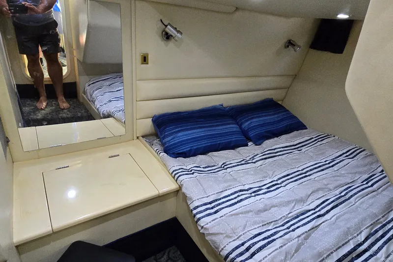 Slide: The Image of Cozy cabin interior of 1994 Sunseeker Mustique 42 yacht with striped bedding. - 25