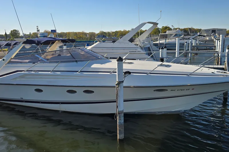 Slide: The Image of 1994 Sunseeker Mustique 42 yacht docked at marina under clear blue sky. - 2