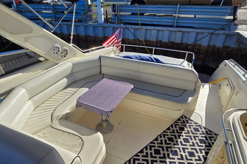 Slide: The Image of Luxurious 1994 Sunseeker Mustique 42 yacht interior with cushioned seating and small table. - 13